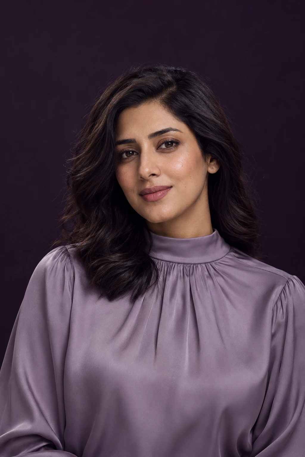 Natural beauty portrait in a lilac blouse against a plum studio backdrop